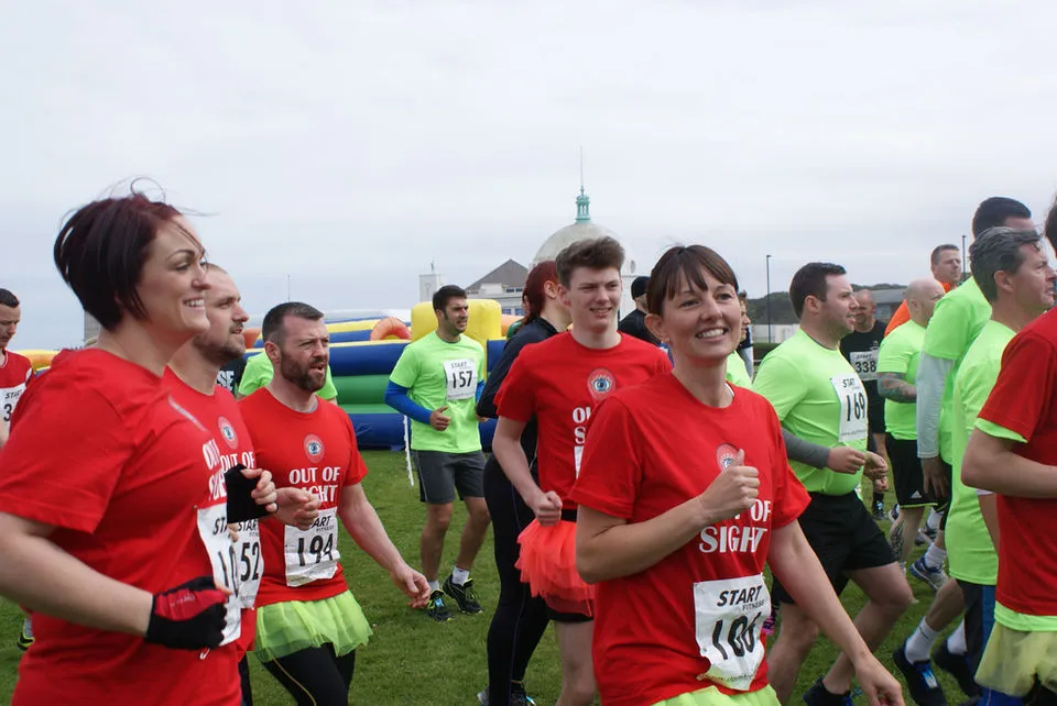 Several volunteers for Out of Sight are participating in a charity run.