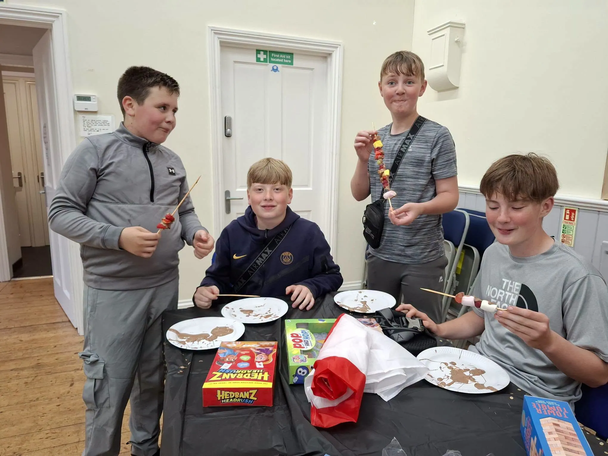 The boys enjoy fruit dipped in melted chocolate