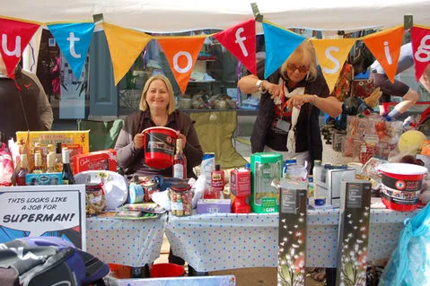 The founder of the charity and a volunteer with a donation bucket77.